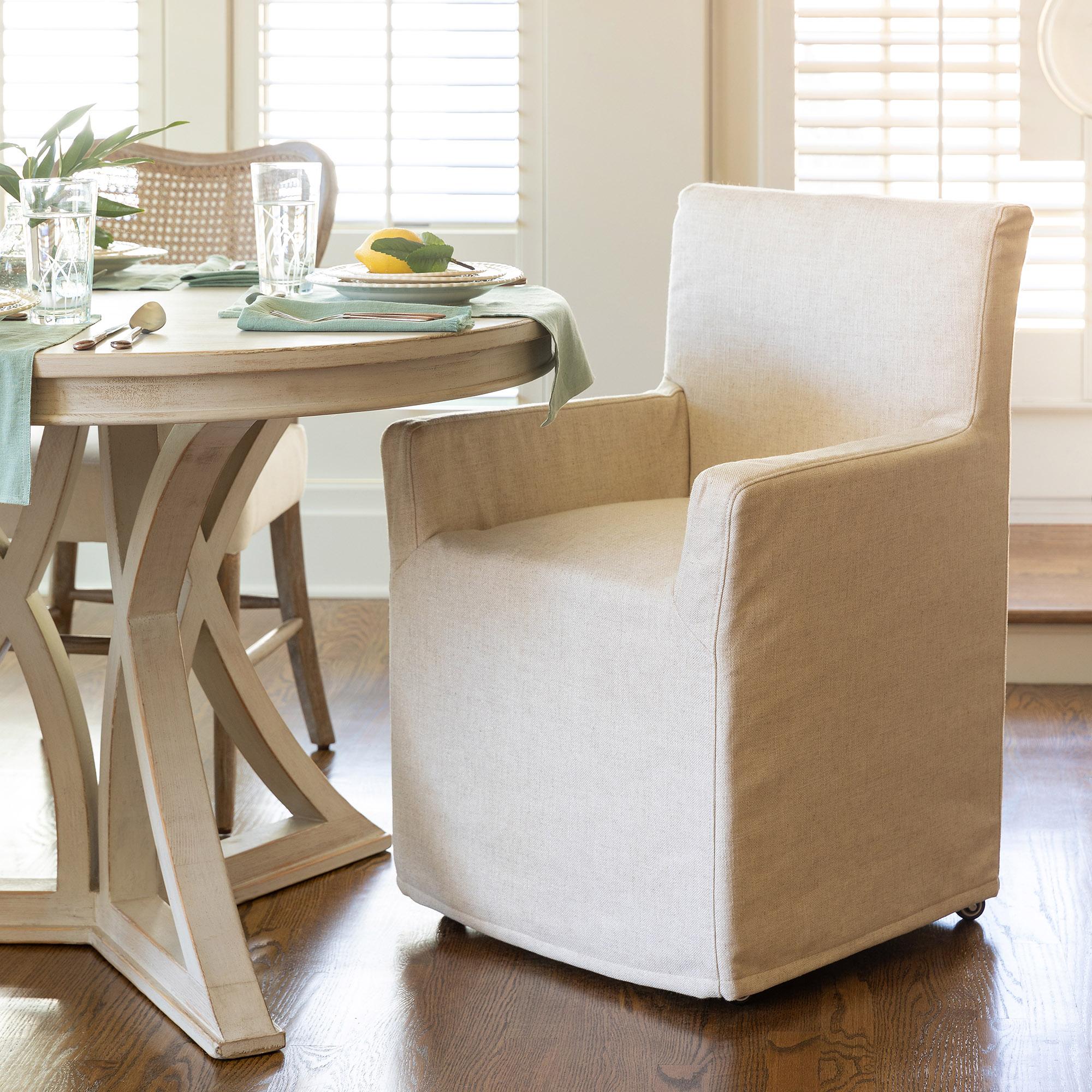 Slipcovered dining discount chairs with arms